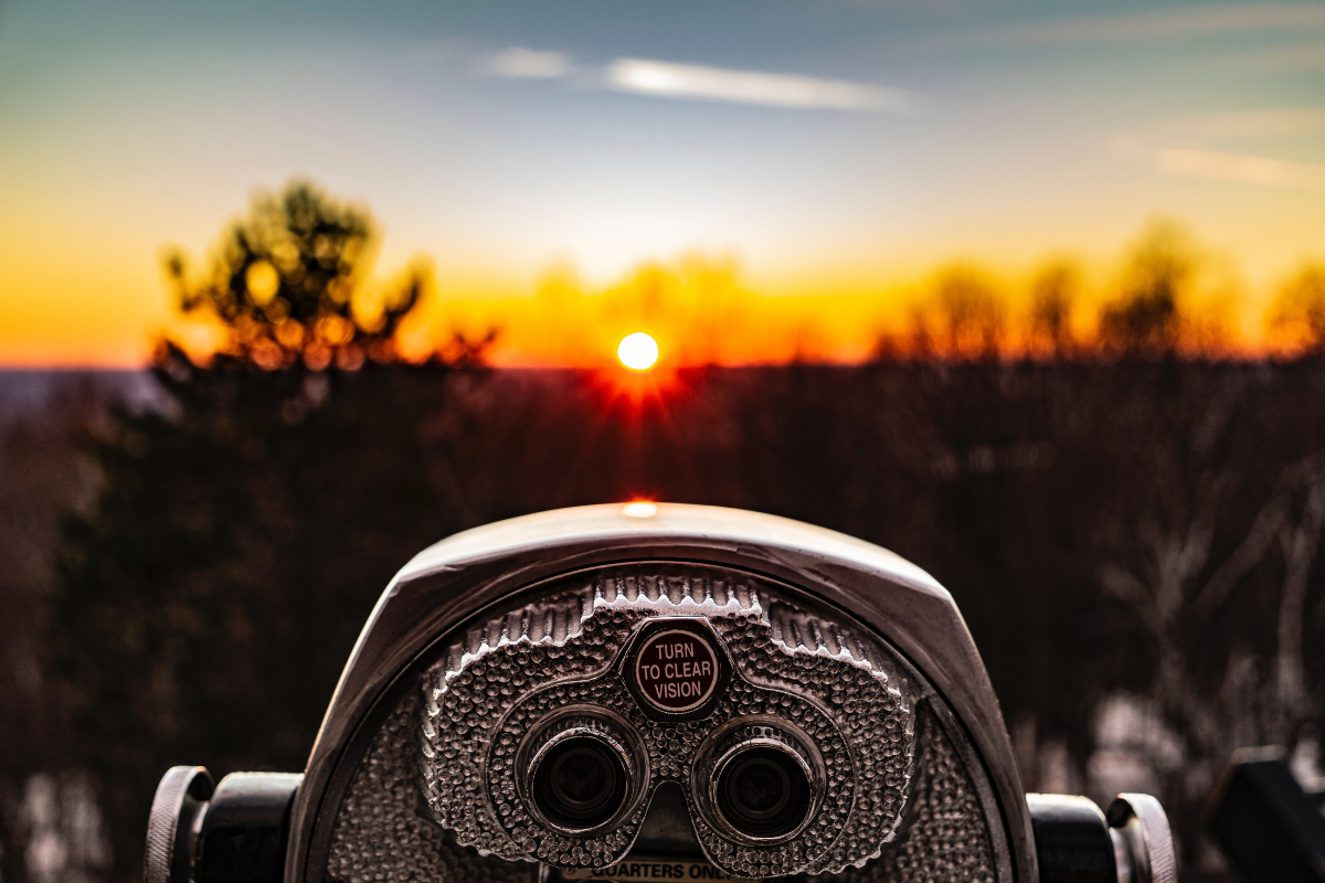 Landscape view of a sunset with a viewer in the front focus