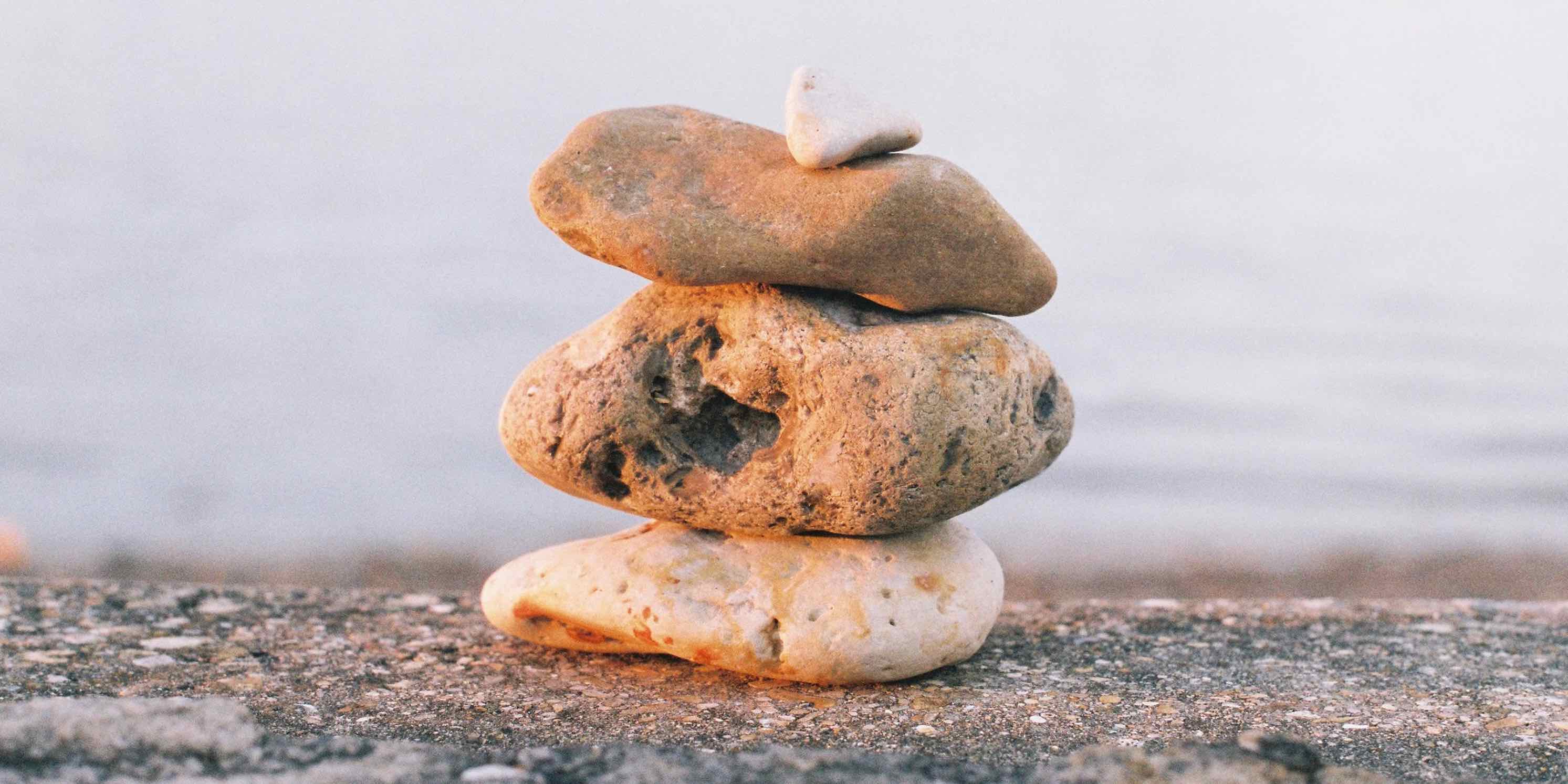 Layered stones on a beach at sunset